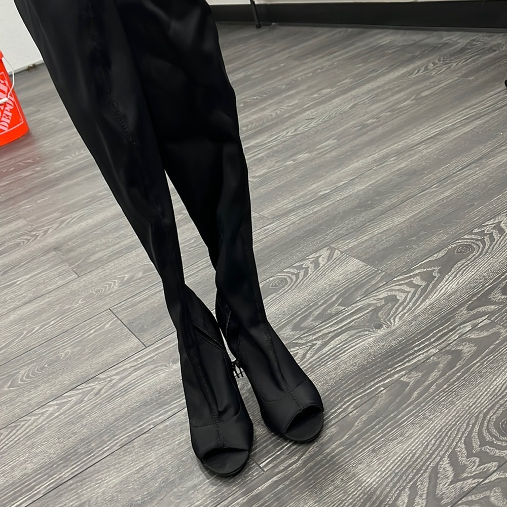 Black peep toe to the knees boots size 6.5.
